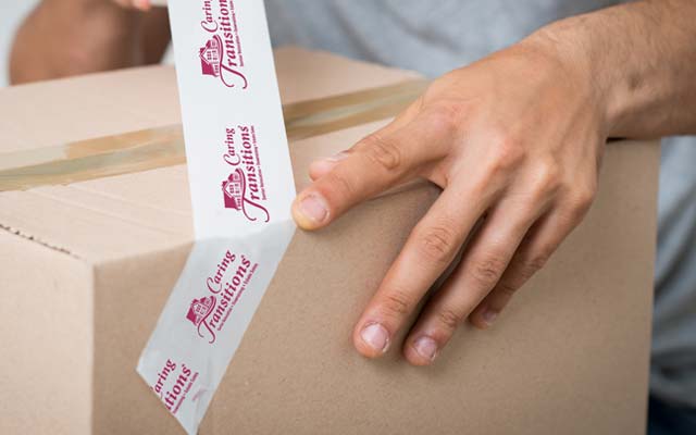 Caring Transitions branded packing tape and box
